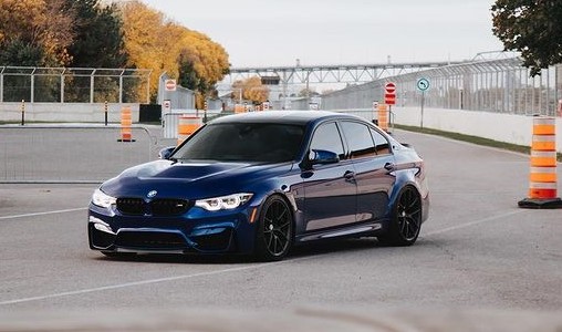 a blue car on a road